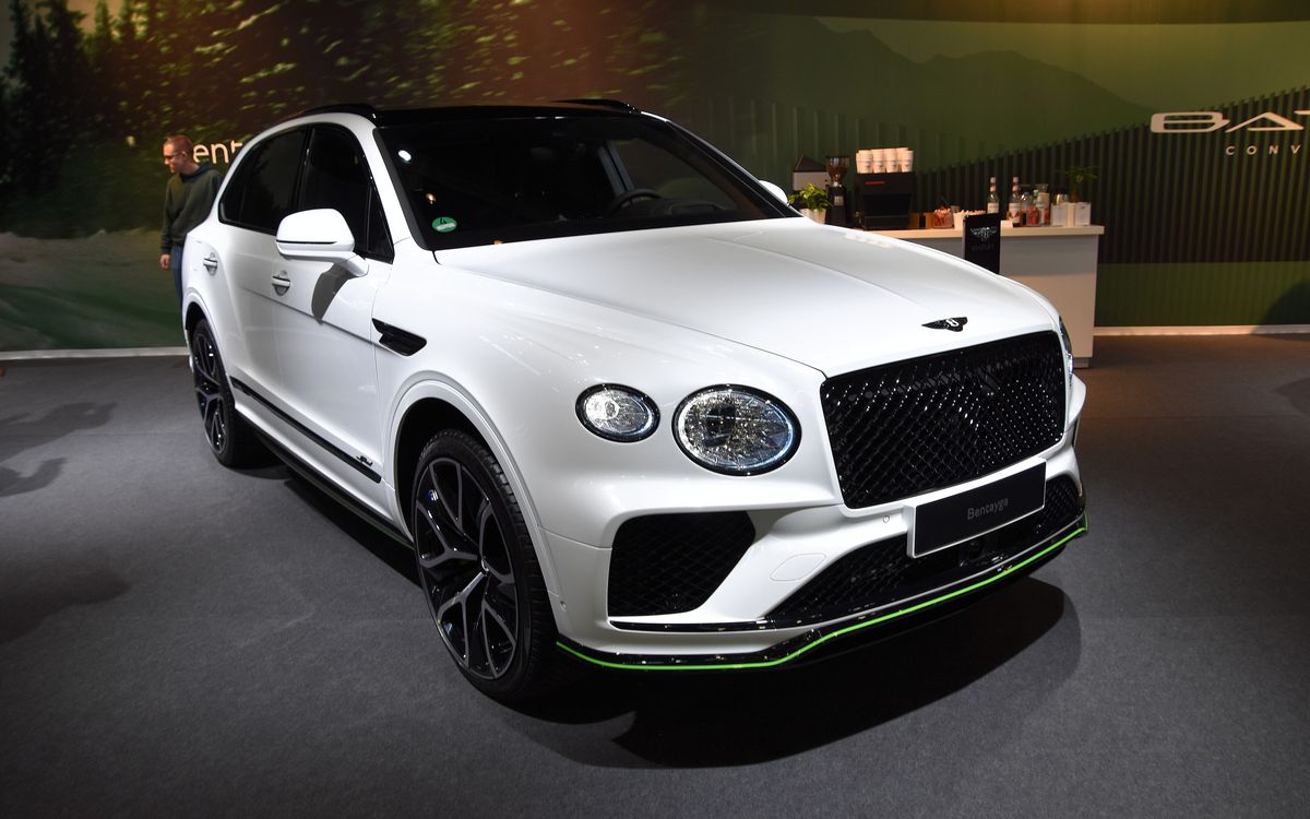 White Bentley Bentayga Speed on a show stand, front three-quarter view