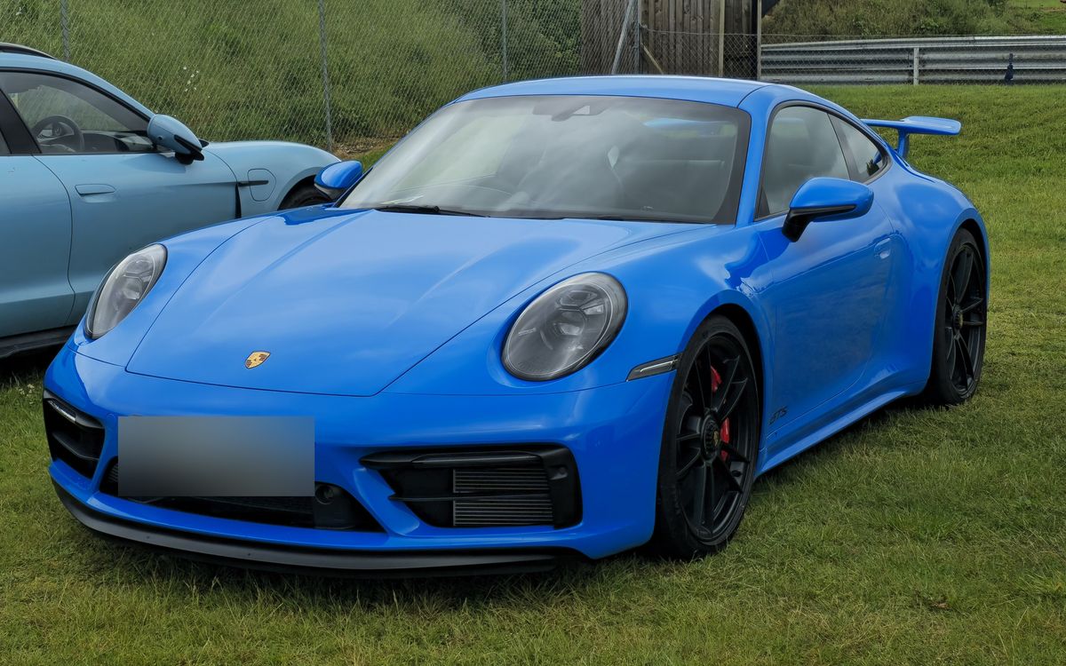 Blue Porsche 911 (992) Carrera GTS coupé, front three-quarter view