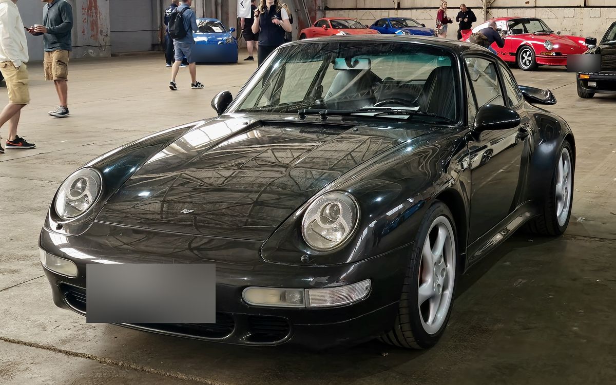 Black Porsche 911 Turbo (993) coupé, front three-quarter view